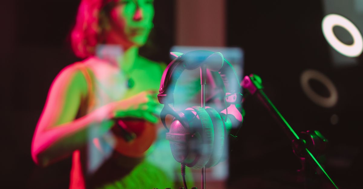 A futuristic recording studio with a glowing hologram of a music waveform and a human musician looking conflicted