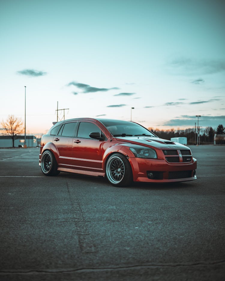 Parked Red Dodge Caliber On Asphalt Road