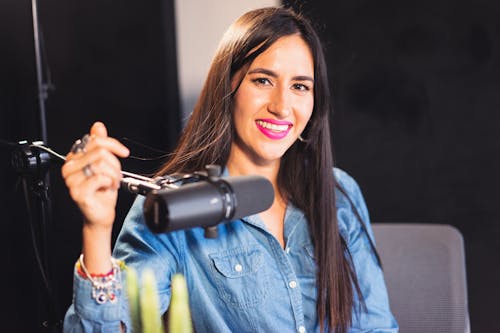 Woman Smiling Next to a Microphone