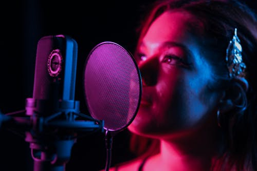 A Woman Singing in Front of the Pop Filter