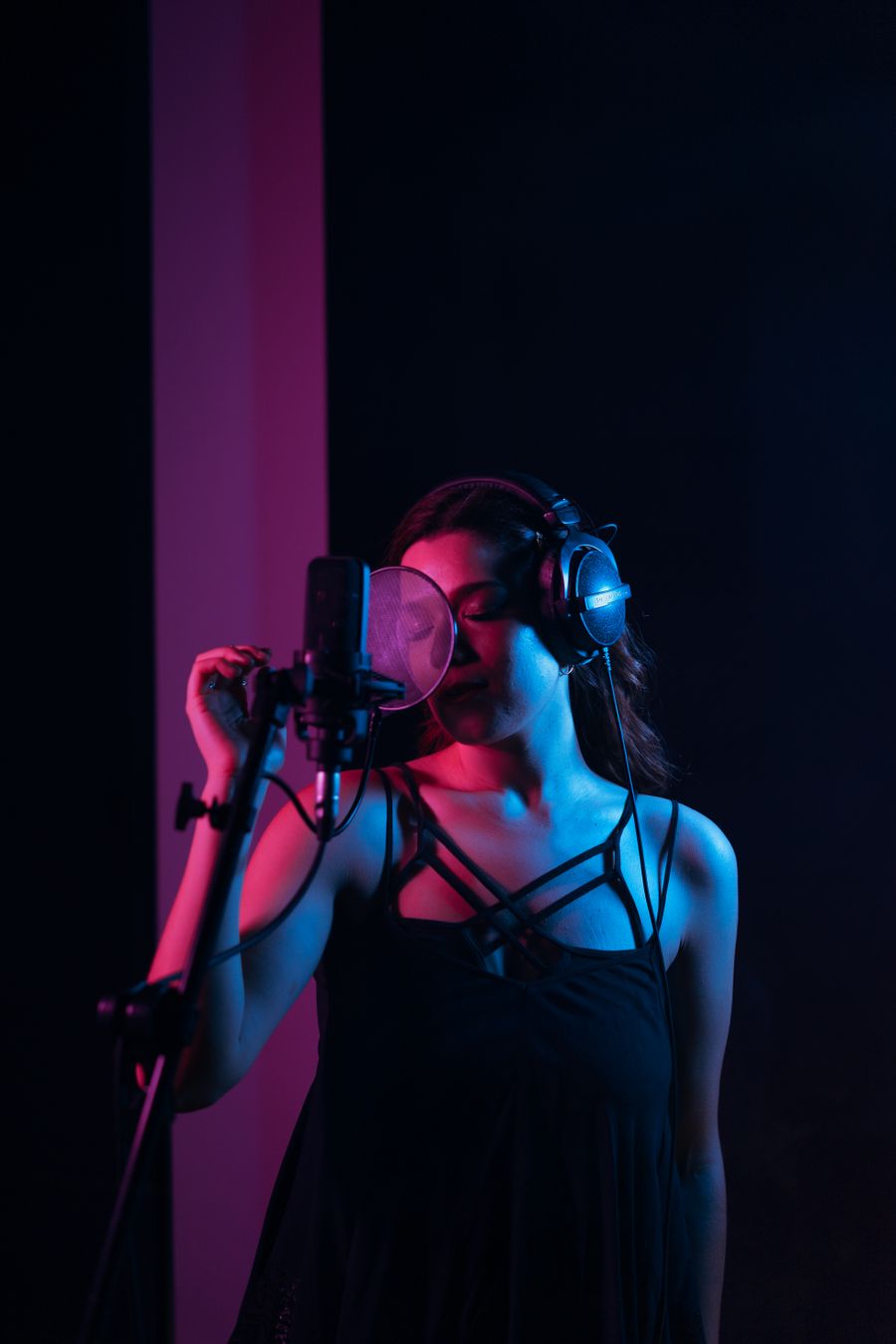 Vocalist warming up under warm studio light