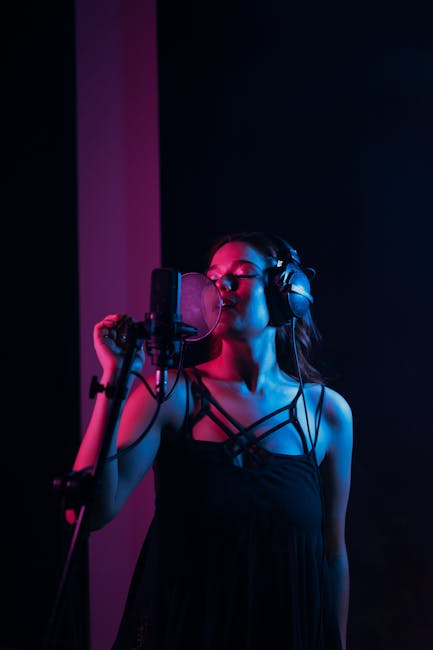 Photo of a Woman Singing in a Recording Studio with Her Eyes Closed ...