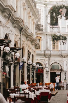 Charming outdoor restaurant with classic architecture and tables set for dining.
