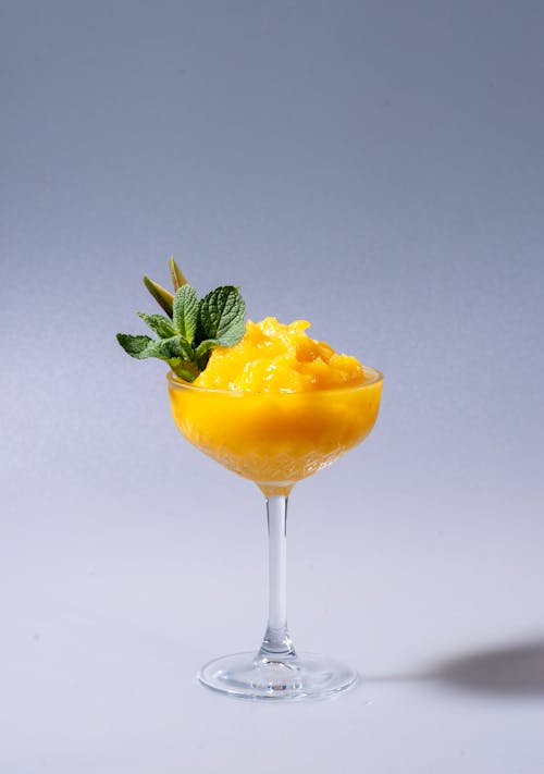 Free A Yellow Chilled Drink on a Clear Cocktail Glass Stock Photo