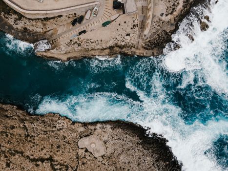 Aerial photograph capturing the stunning coastline of Il-Qrendi, Malta with crashing ocean waves.