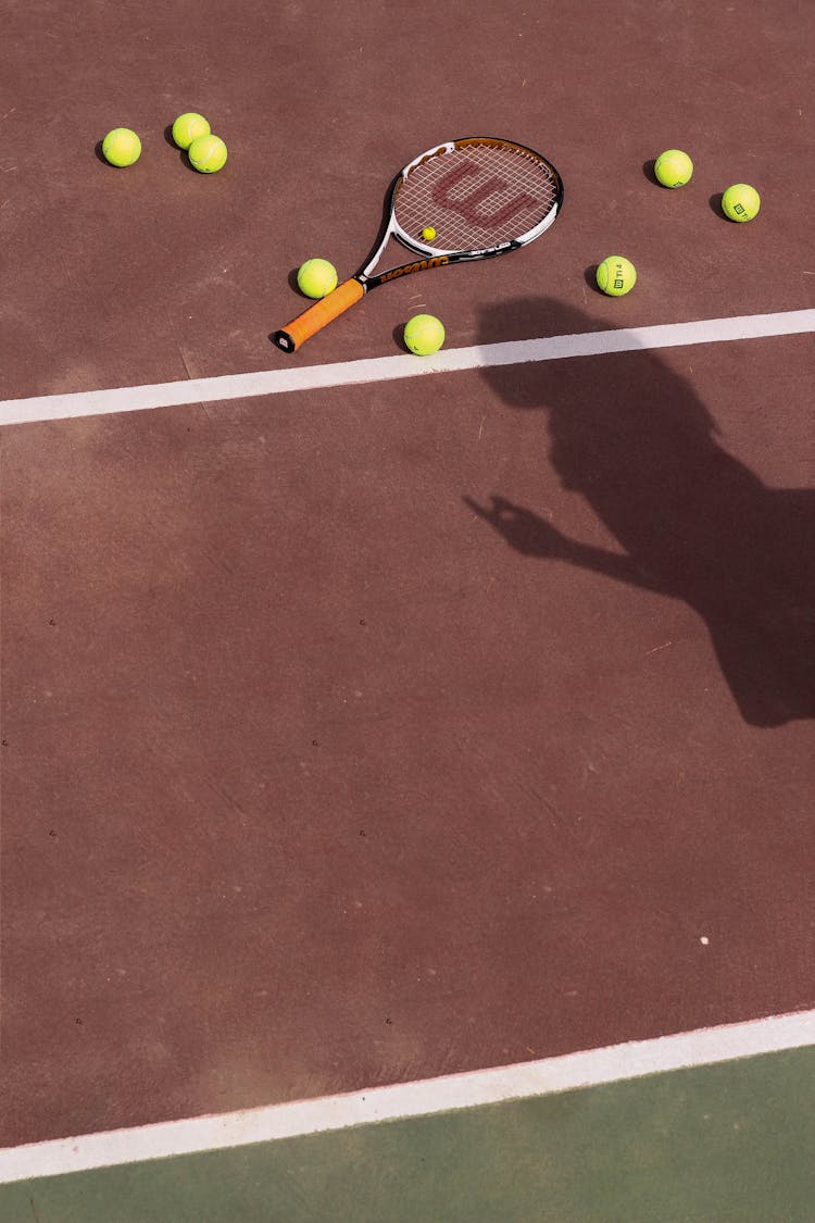 Tennis Racket On Brown Floor