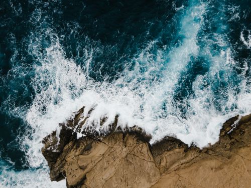 Free A stunning aerial view of waves crashing against the rocky coastline in Il-Qrendi, Malta. Stock Photo