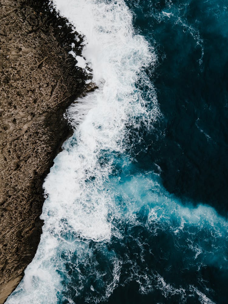 An Ocean Waves Crashing On A Rock Formation