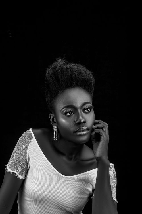 Free Elegant black and white portrait of a woman with earrings and off-shoulder top. Stock Photo