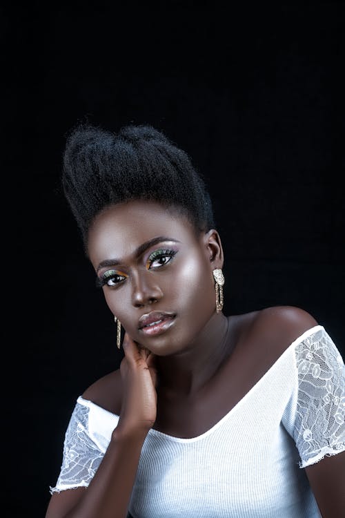 Beautiful Woman Wearing White Top With Hand on Face