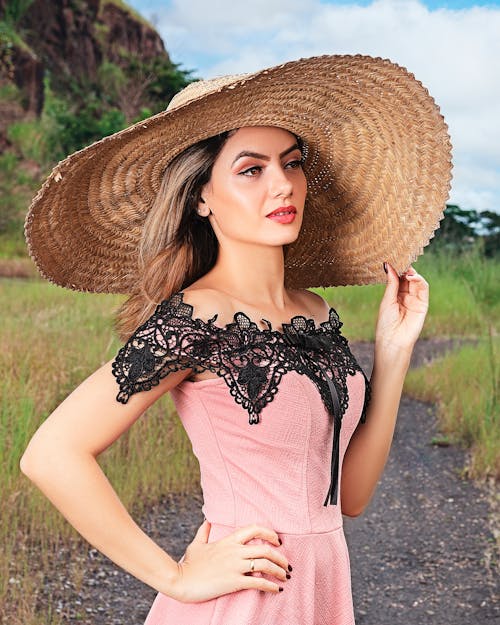 A Woman in Pink Dress Wearing Brown Hat