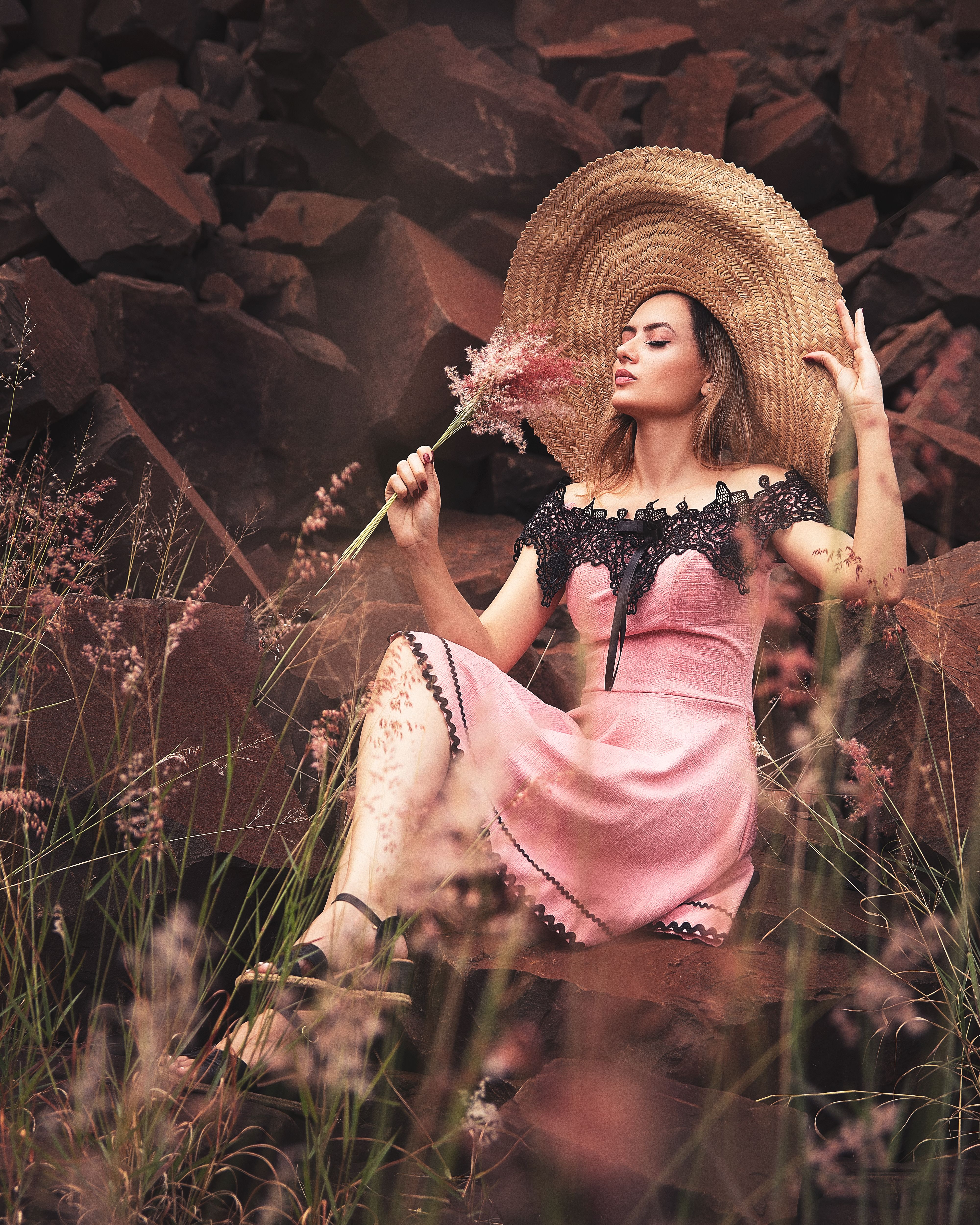 Woman Wearing Pink Dress and Sun Hat Holding a Bunch of Flowers · Free ...