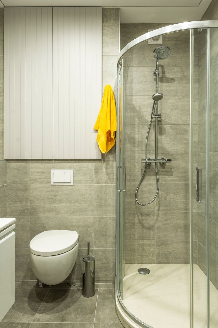 Compact bathroom update with tile, shower enclosure, and clean fixtures.