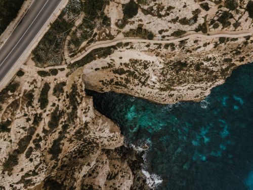 Free Stunning aerial view of Malta's rocky coastline and vibrant turquoise waters, captured from above. Stock Photo