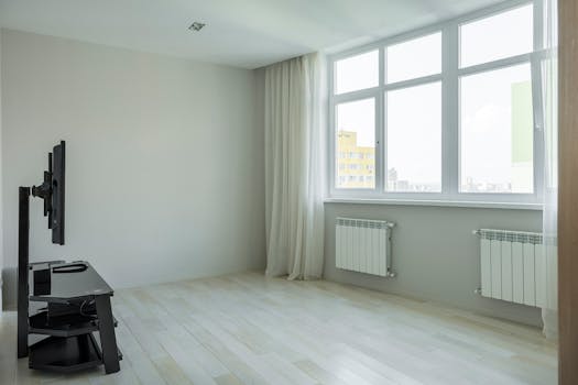 Spacious and bright minimalist apartment with large windows and hardwood floors.