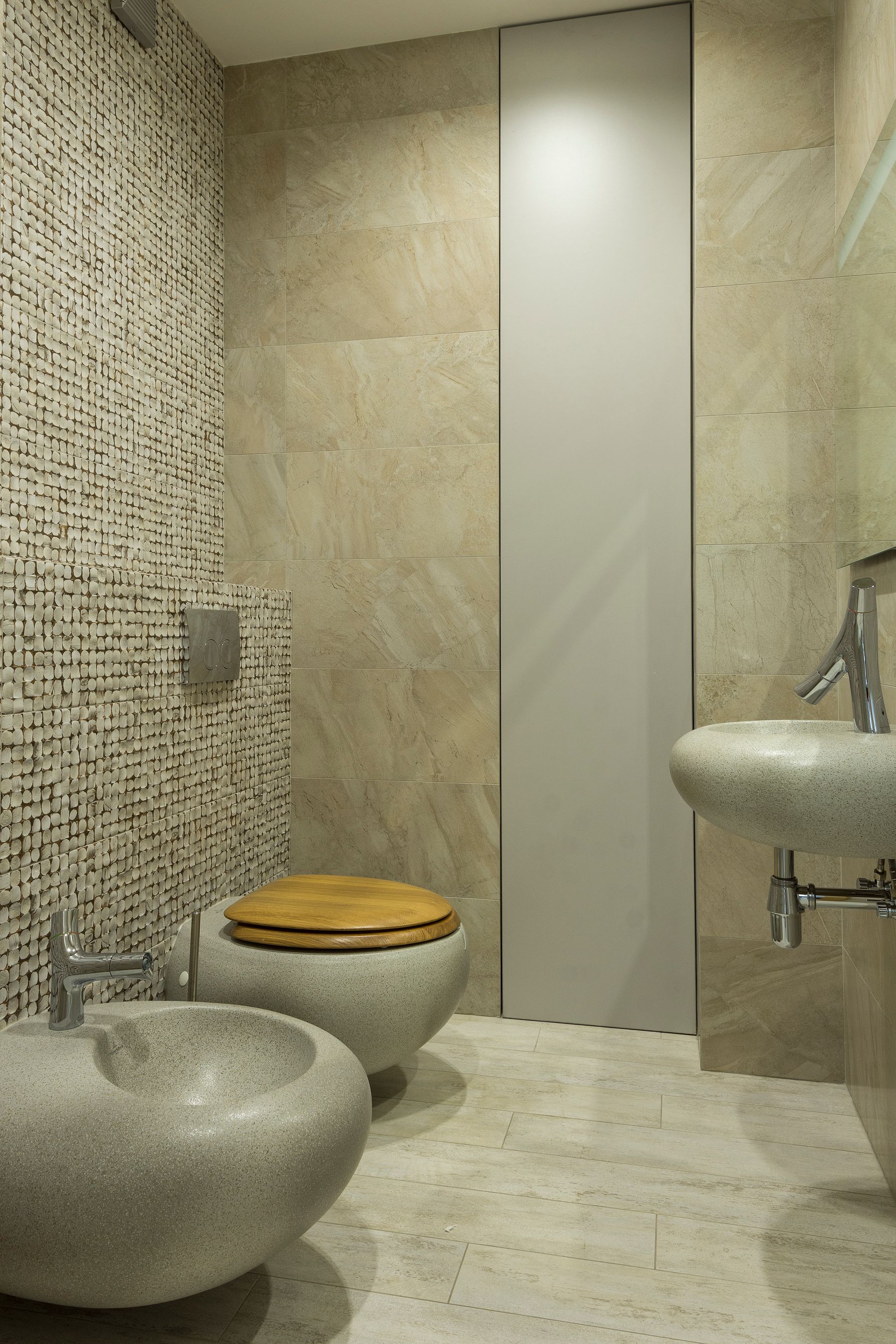Calm bathroom vanity with pale stone surface and warm neutral materials