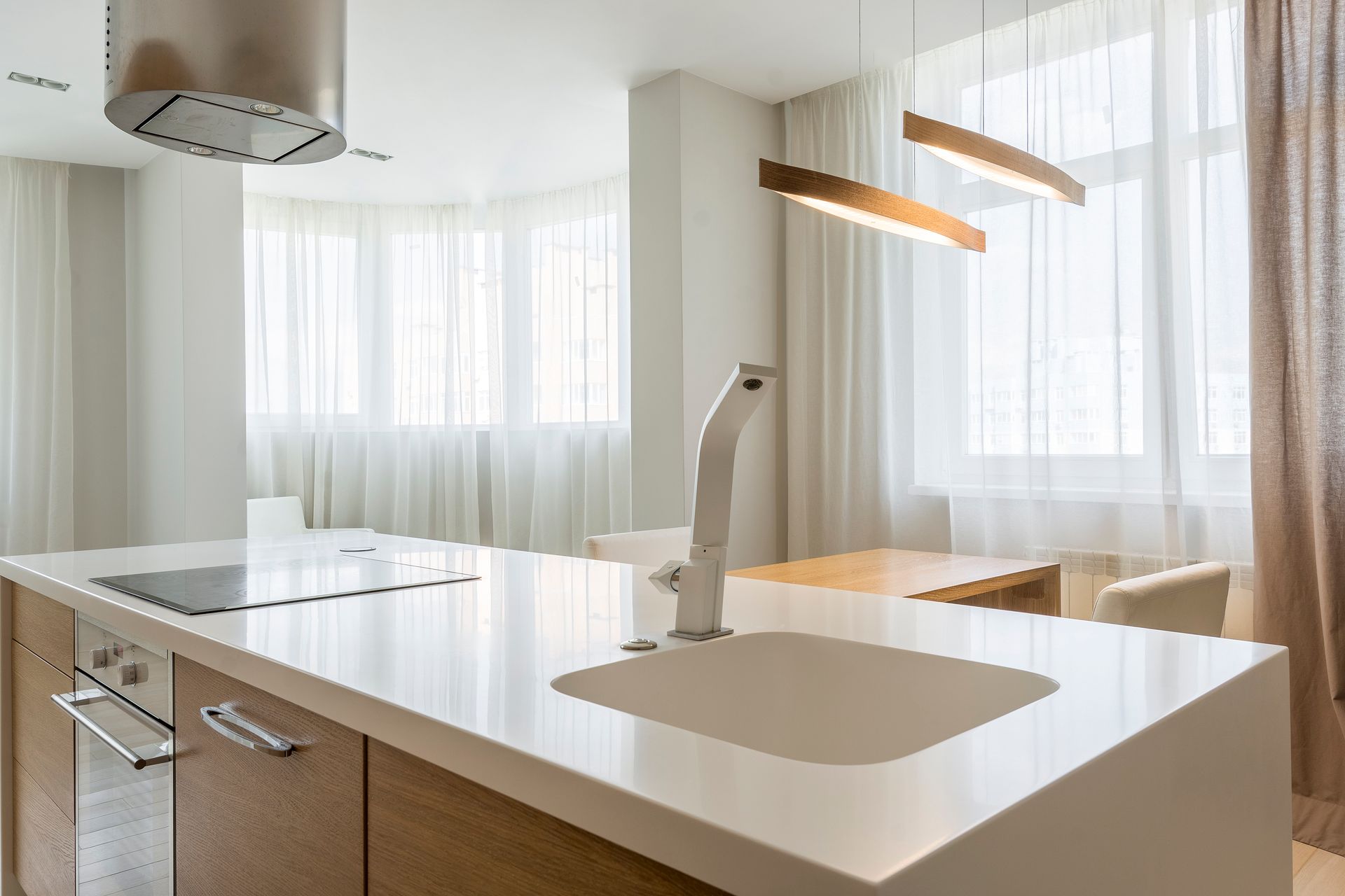 Bright minimalist kitchen with modern fixtures and open design concept.