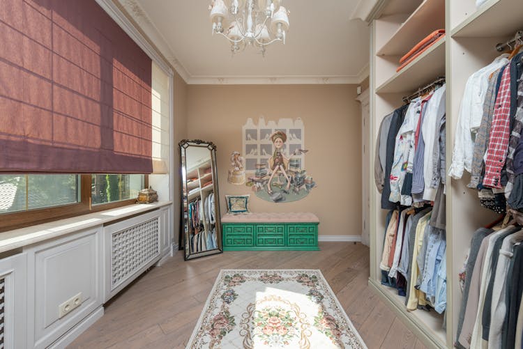 A Walk In Closet With Clothes Hanging