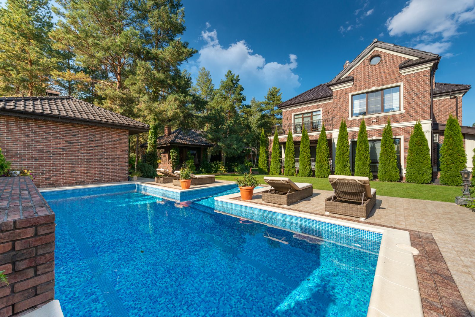Grand brick residence with landscaped outdoor swimming pool