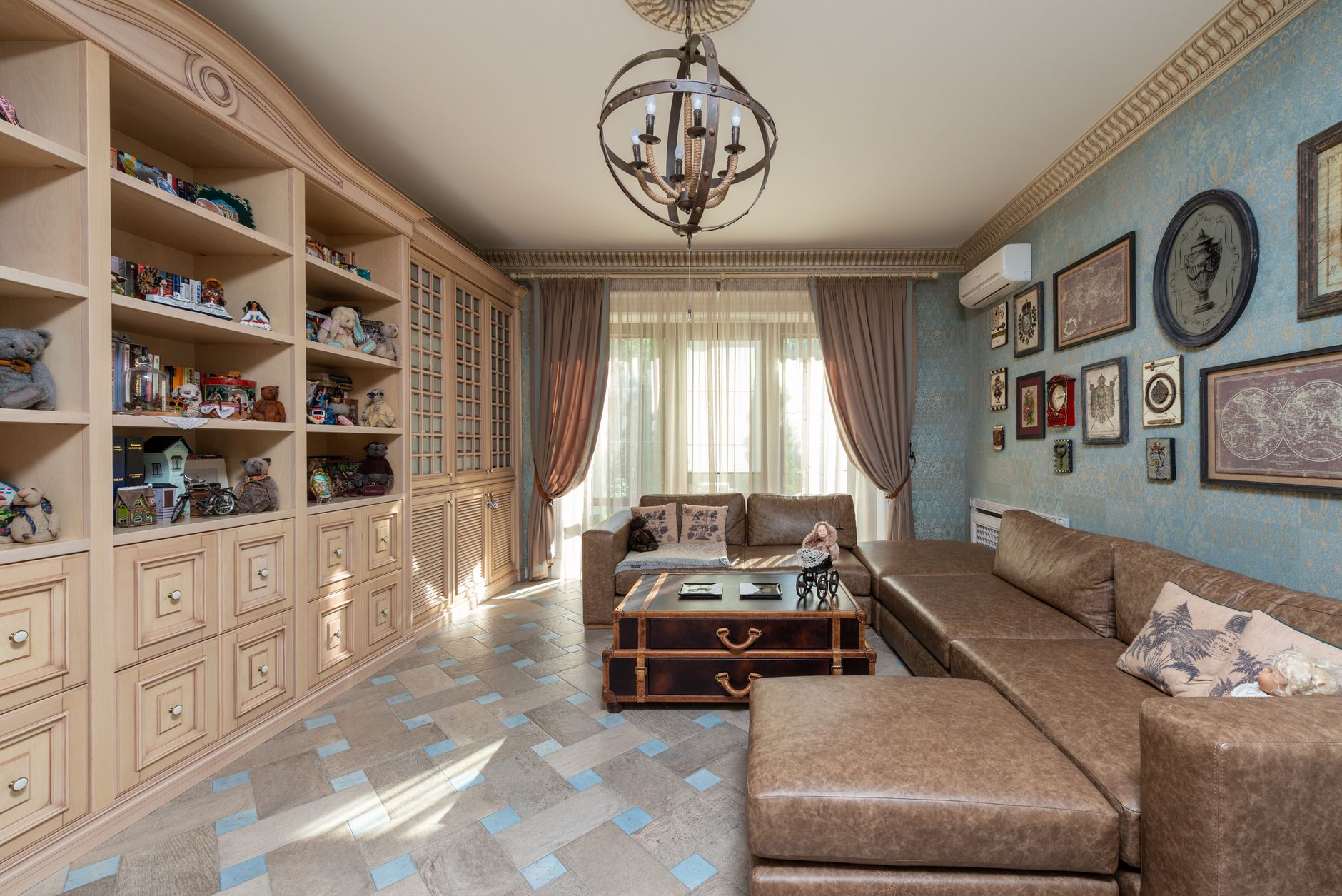 high end apartment storage for cozy homes Spacious living room featuring classic decor with bookshelves, leather sofa, and wall art.