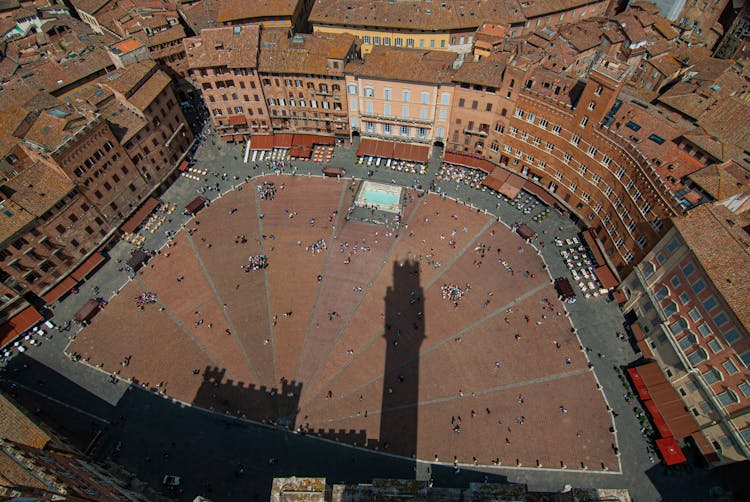 Aerial View Of People In A Courtyard Surrounded With Buildings