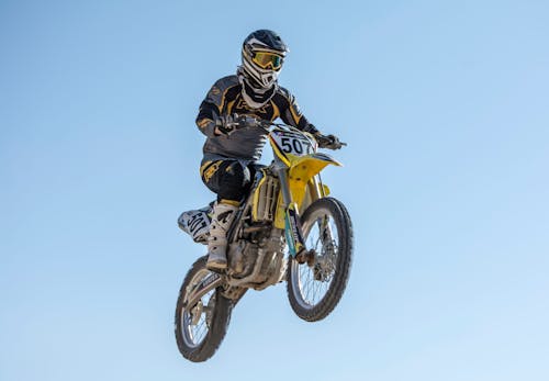 A Low Angle Shot of a Person Riding a Motorcycle