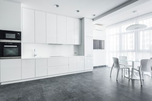Free Sleek white kitchen with modern appliances and minimalist design. Stock Photo