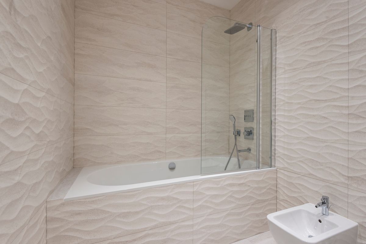 Bathroom with beige textured tiles