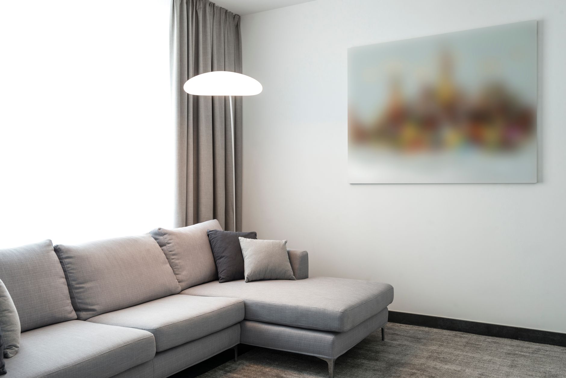 Elegant modern living room featuring a comfortable gray sofa, soft lighting, and minimalist decor.