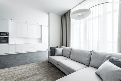 A Cozy Living Room Near the Kitchen with Cabinets