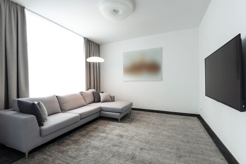 Spacious L-shaped grey sofa in modern living room
