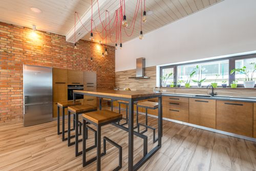 Free Spacious and stylish kitchen featuring modern industrial design with wooden and metal elements. Stock Photo