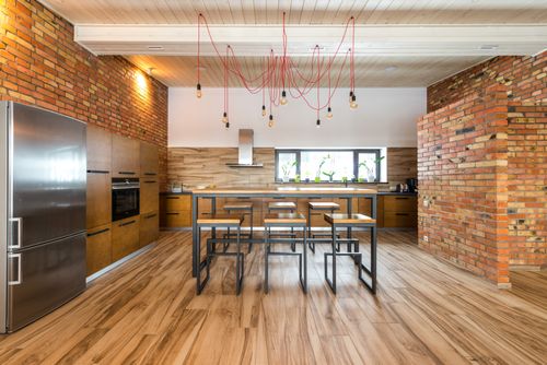 Free Spacious kitchen interior with industrial design, featuring brick walls and wooden accents. Stock Photo
