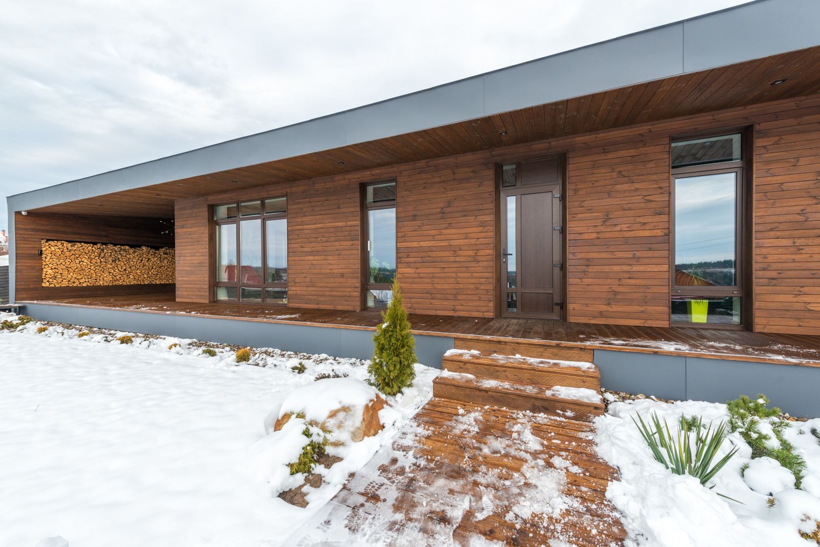 Timber home with large energy-efficient windows in winter, illustrating energy-efficient windows in Scotland