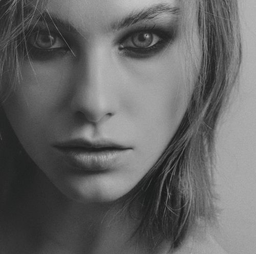 Free Dramatic black and white close-up portrait of a woman with intense eyes and detailed features. Stock Photo