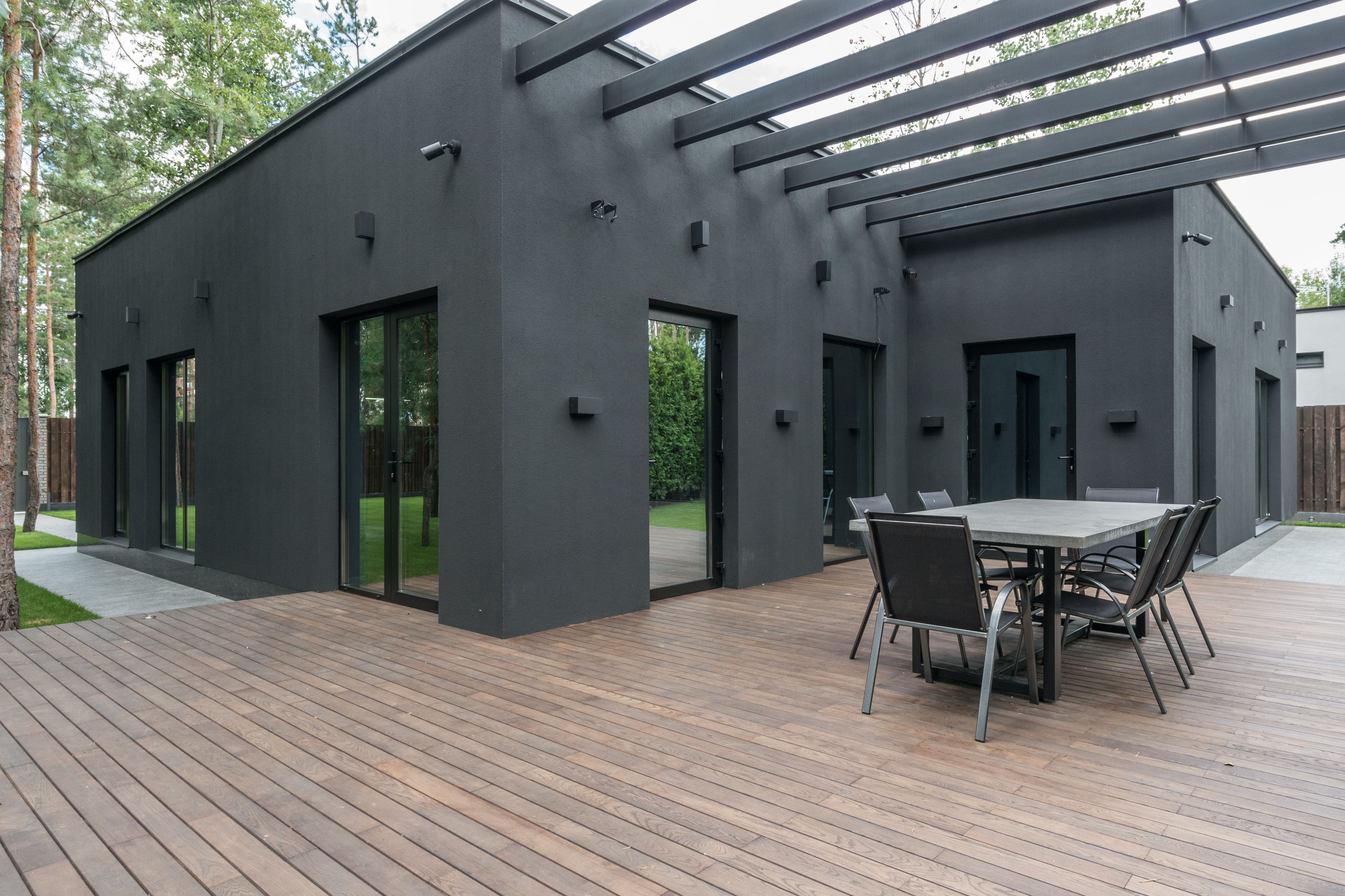 Modern shared deck with pergola and dining area