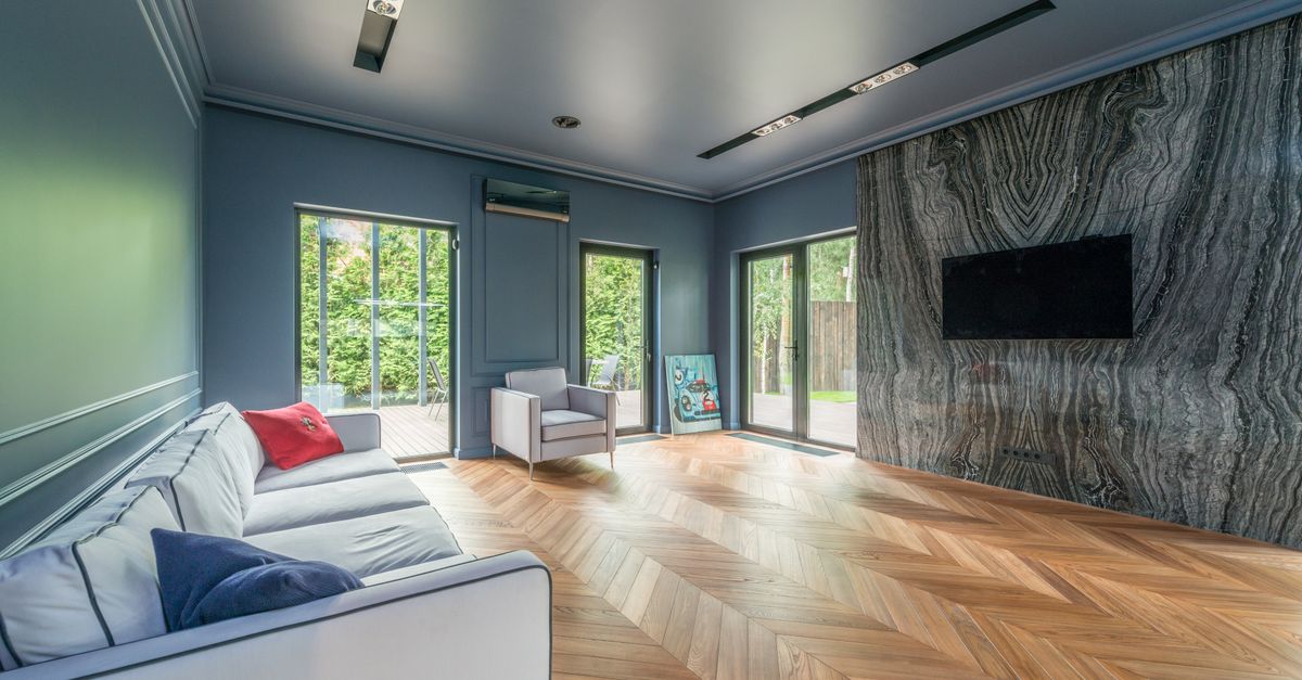 Bright modern living room interior with daylight, sofa and clean wooden floor