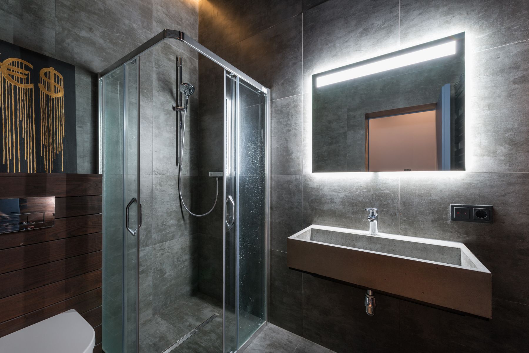 Minimal bathroom with broad continuous wall surfaces and restrained material transitions
