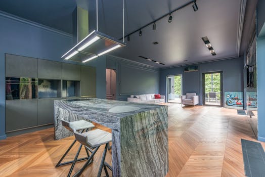 Spacious modern kitchen and living room with parquet flooring and minimalist design.