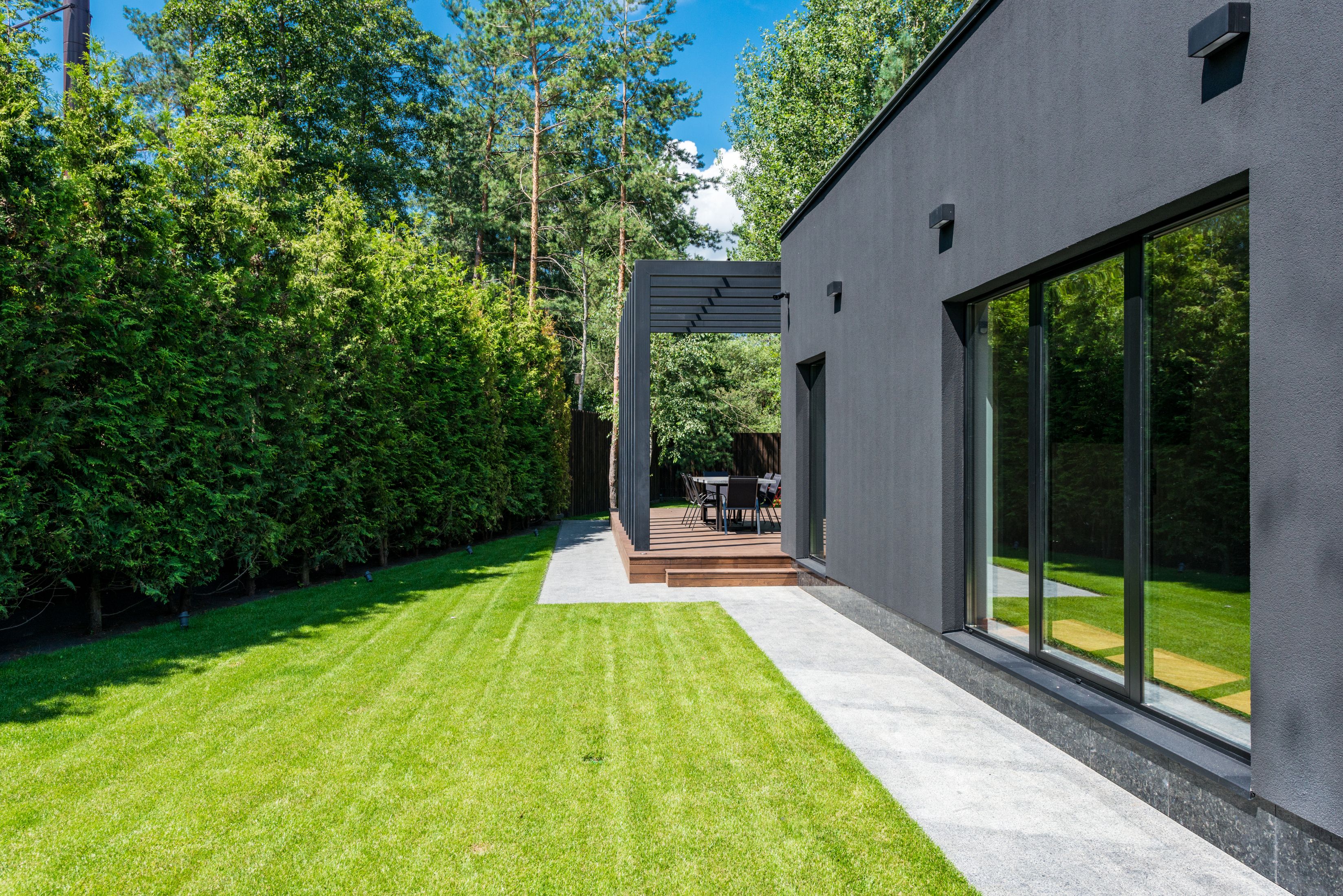 Sleek modern home with green yard
