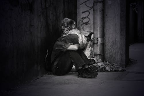 Monochrome Photo of a Homeless Man