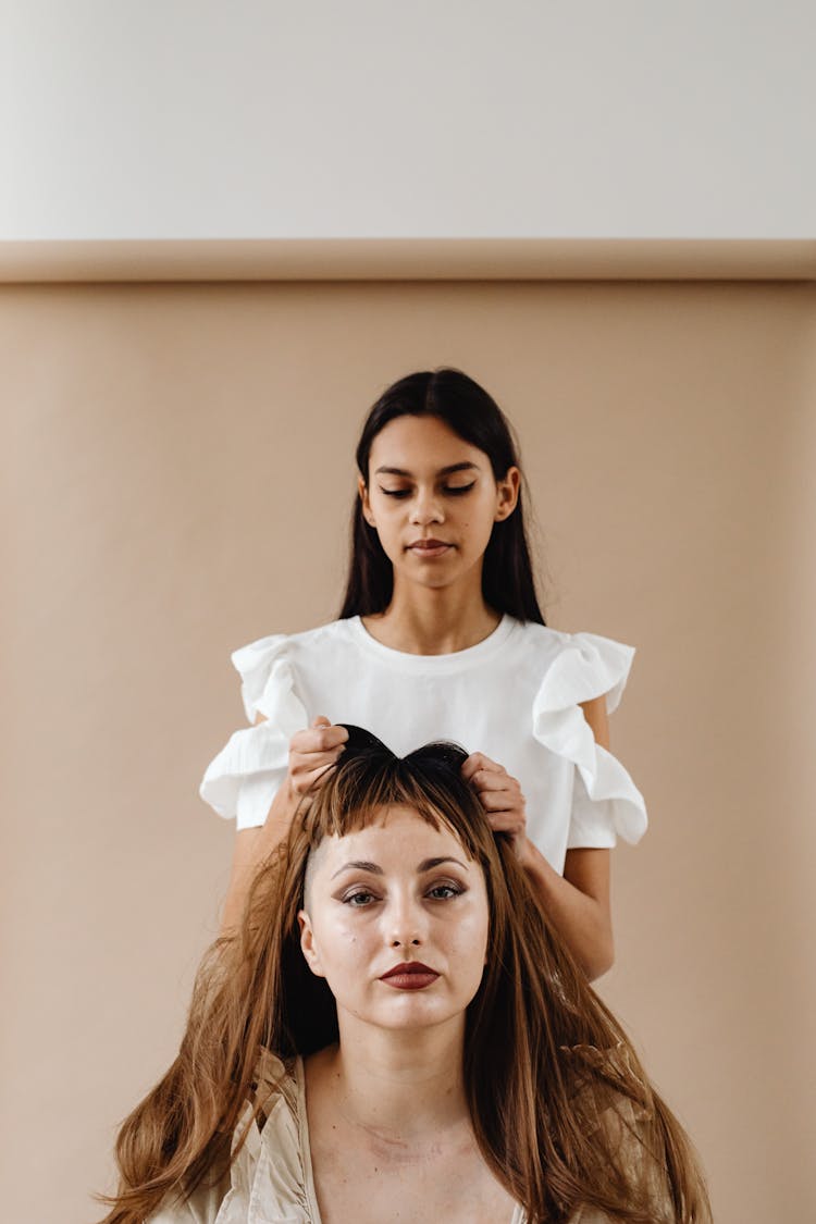 A Woman Putting A Wig