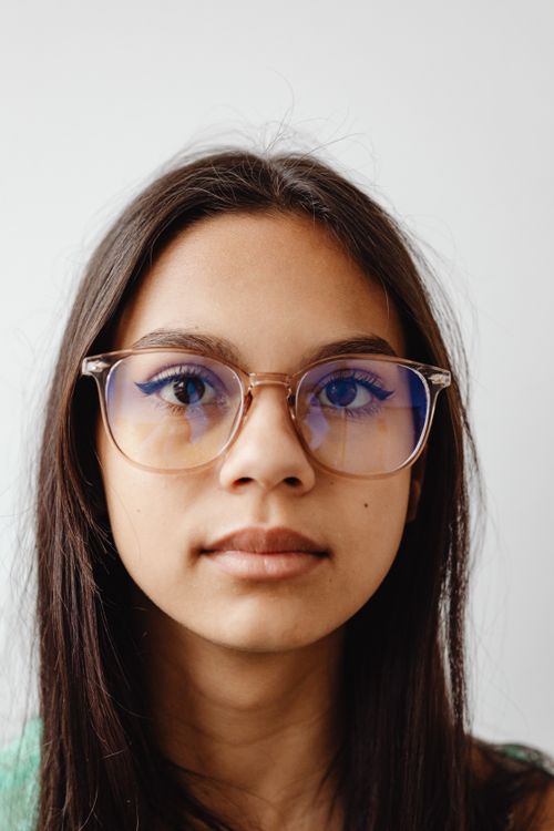 Free Portrait of a young woman wearing eyeglasses, displaying a neutral expression. Stock Photo