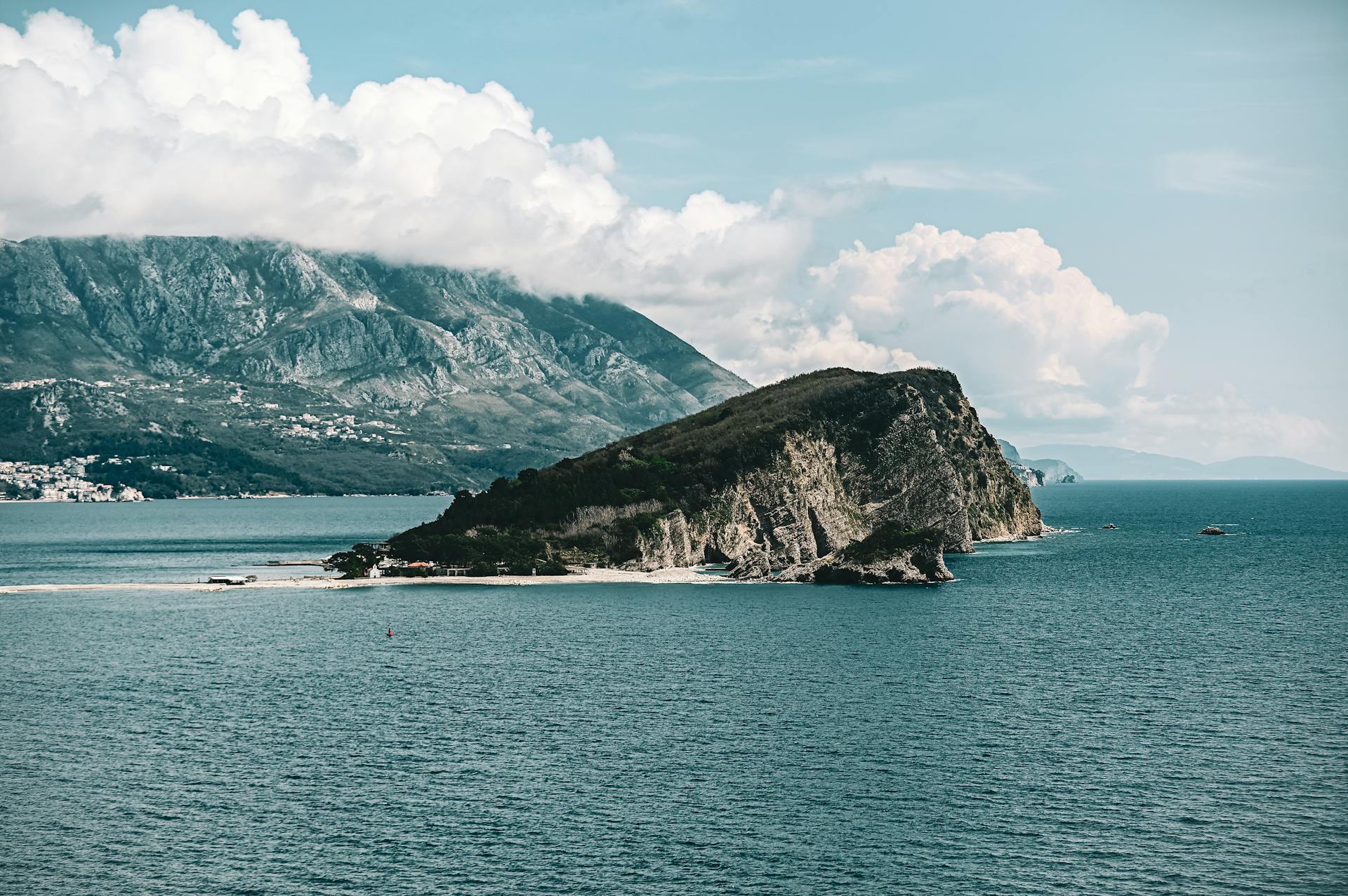 A breathtaking view of Sveti Nikola Island with mountains and ocean in Montenegro.