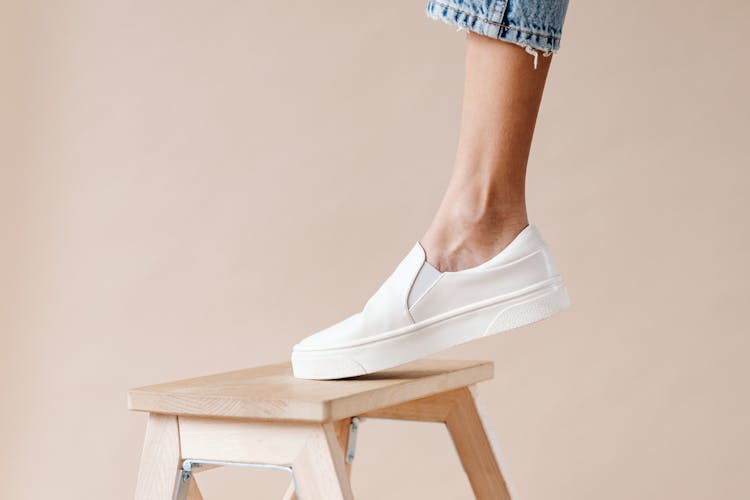 Person Stepping On A Wooden Stool