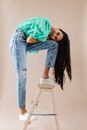 A Woman Posing in a Wooden Ladder