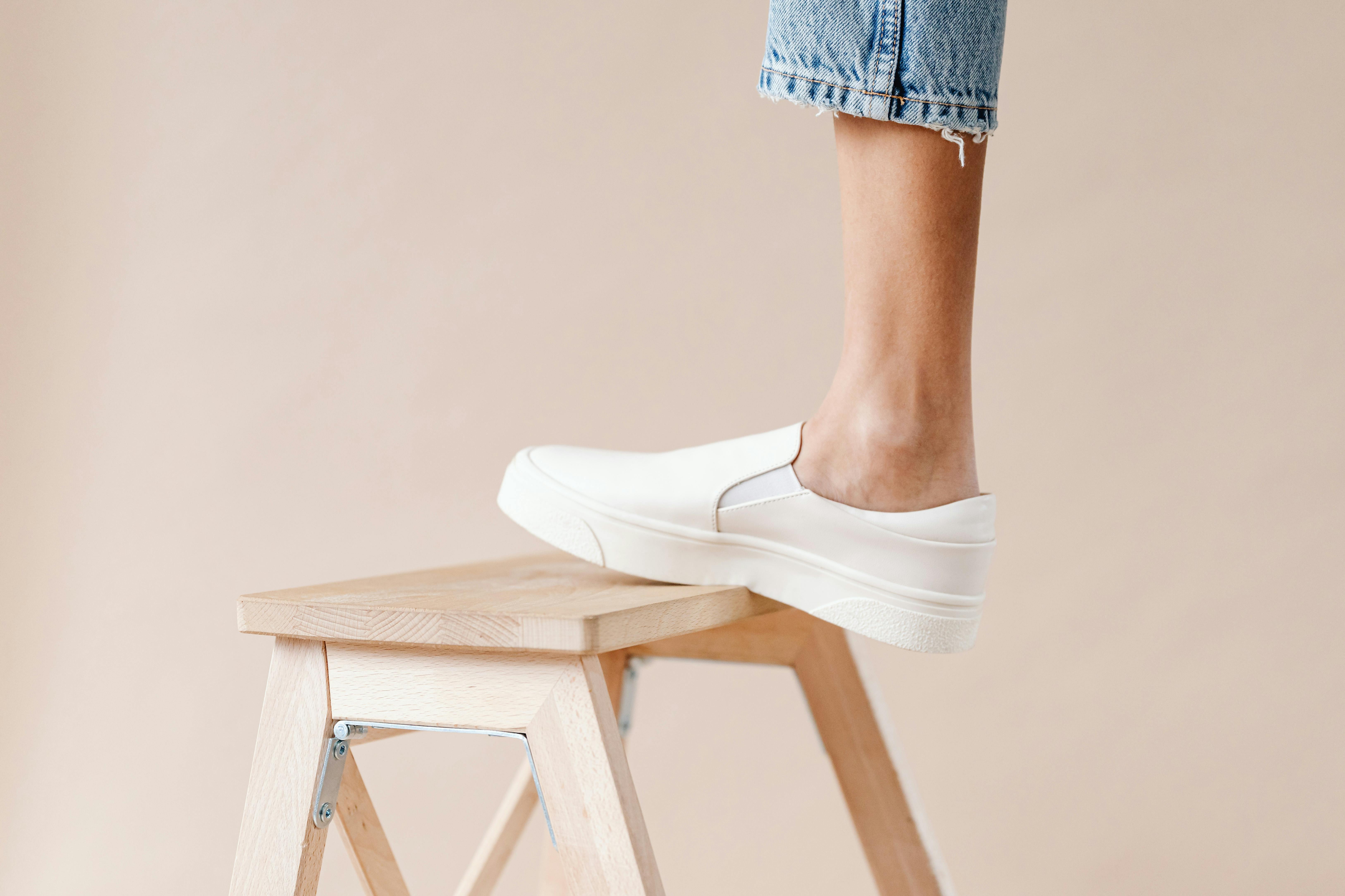 New White Shoes And Care Supplies On Gray Wooden Floor. Brush And Spray To  Keep Footwear Look Good. Stock Photo, Picture and Royalty Free Image. Image  139334039.