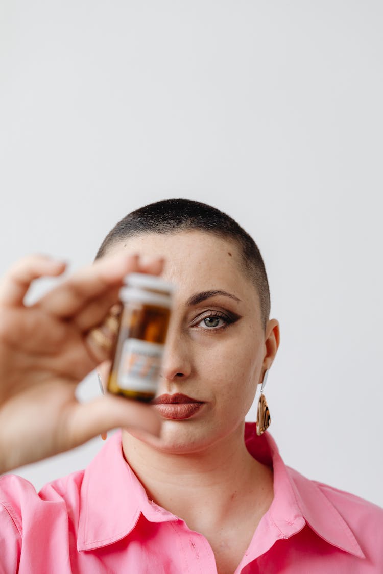 A Beautiful Woman Holding A Medicine Bottle