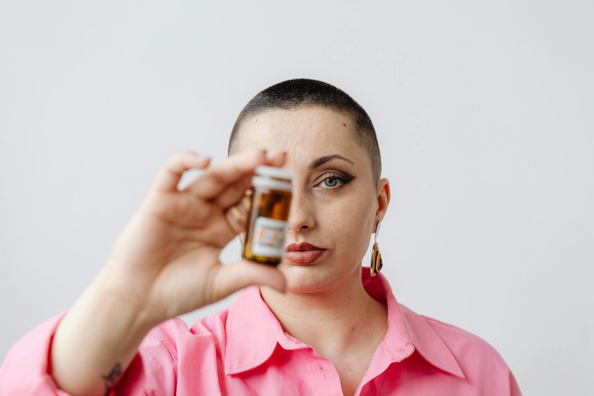 A Woman Holding a Medicine Bottle