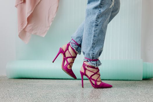 Trendy fashion scene featuring jeans and vibrant pink stilettos, embodying modern style.